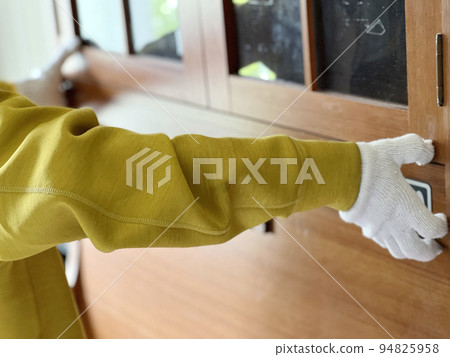 Hands with gloves carrying the cabinet Hands with gloves carrying the cabinet 94825958