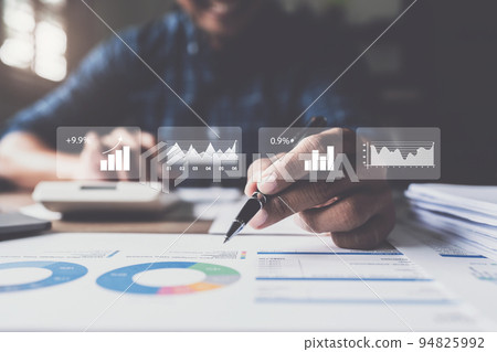 Businessman hand holding pen and pointing at financial paperwork with social network diagram Businessman hand holding pen and pointing at financial paperwork with social network diagram 94825992