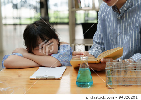 Kid sleeping while doing science experiments. Education science concept 94826201