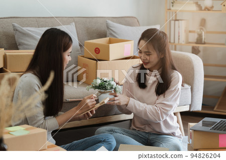 Two Asian SME business woman working at home office. online shopping concept Two Asian SME business woman working at home office. online shopping concept 94826204