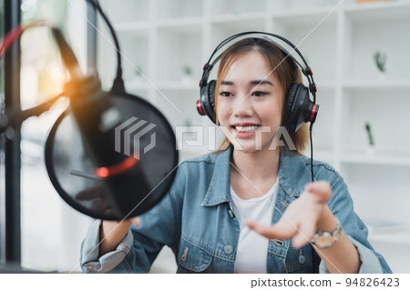Asian podcaster making audio podcast working at home studio Asian podcaster making audio podcast working at home studio 94826423