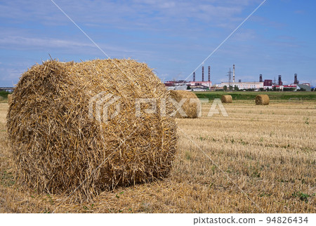 Haystacks with a view of the factory in the background Haystacks with a view of the factory in the background 94826434