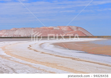 Toxic lake with potash waste hills 94826438