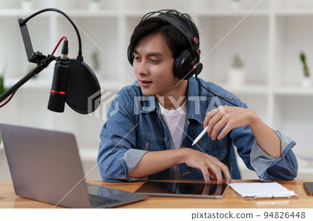 Asian podcaster making audio podcast working at home studio Asian podcaster making audio podcast working at home studio 94826448