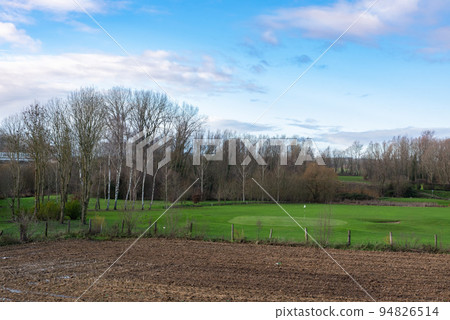 Agriculture fields, meadows and bare winter trees at the borders of Anderlecht, Brussels 94826514