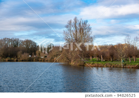 Agriculture fields, meadows and bare winter trees at park lakes of Anderlecht, Brussels Agriculture fields, meadows and bare winter trees at park lakes of Anderlecht, Brussels 94826525