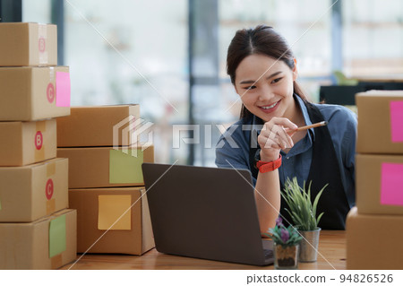 Portrait of modern Asian SME business woman entrepreneur at home office 94826526