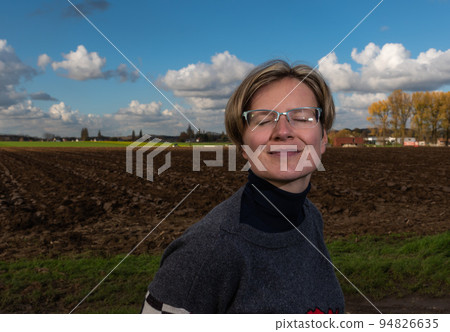 Active thirty year old woman posing in the Flemish countryside fields in autumn 94826635
