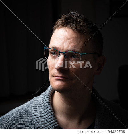 Studio portrait of a 41 year old business man, wearing a gray pull over Studio portrait of a 41 year old business man, wearing a gray pull over 94826768