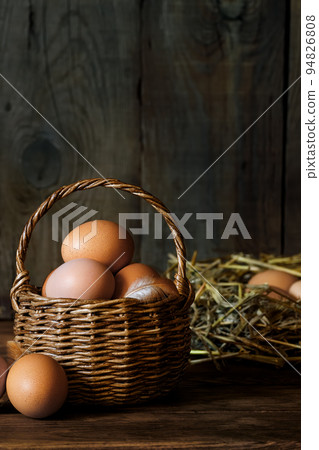 chicken eggs in wicker basket and in hay chicken eggs in wicker basket and in hay 94826808