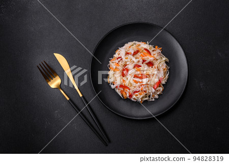 A delicious fresh vegetarian salad of white cabbage, carrot and paprika A delicious fresh vegetarian salad of white cabbage, carrot and paprika 94828319