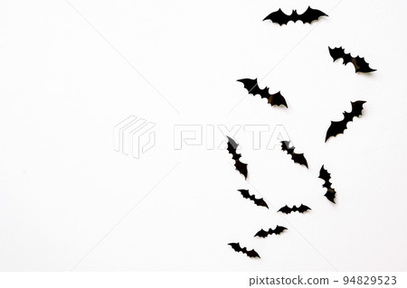 halloween and decoration concept - black 3d paper bats flying over white background. halloween and decoration concept - black 3d paper bats flying over white background. 94829523