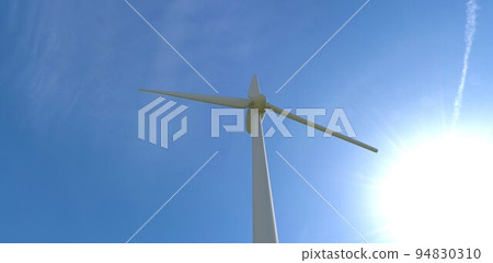 Bottom view of a white fan of an industrial wind turbine against the backdrop of the sun and deep sky. 3d render. Bottom view of a white fan of an industrial wind turbine against the backdrop of the sun and deep sky. 3d render. 94830310