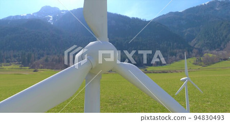A drone view of a wind turbine installed in the forested mountains of the eastern Alps. Clean renewable energy available even at night and in winter. 3d render. 94830493