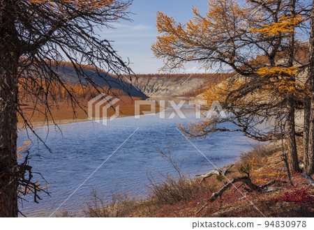 Bright autumn landscape in orange and blue colors on the banks of the Siberian river. 94830978