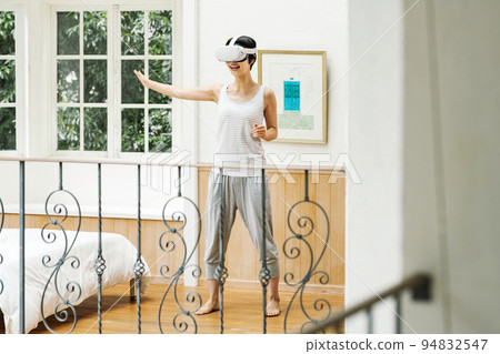 A woman who enjoys VR at home 94832547