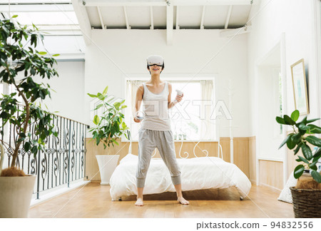 A woman who enjoys VR at home 94832556