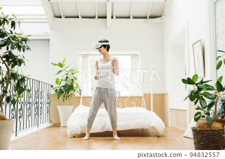 A woman who enjoys VR at home 94832557