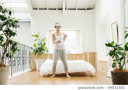 A woman who enjoys VR at home 94832561