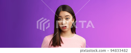 Close-up confused shocked cute young silly asian girl hear strange accusations open mouth gasping stunned, look speechless and puzzled, did not expect such behaviour, purple background Close-up confused shocked cute young silly asian girl hear strange accusations open mouth gasping stunned, look speechless and puzzled, did not expect such behaviour, purple background 94833482