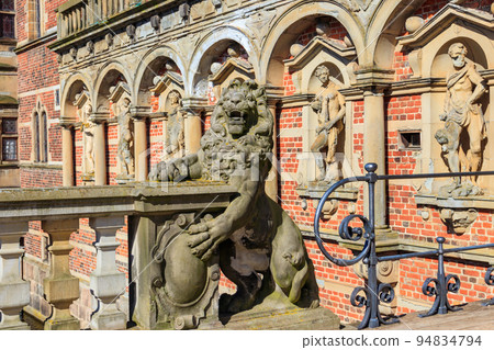 Statue of lion at the entrance to Frederiksborg castle in Hillerod, Denmark Statue of lion at the entrance to Frederiksborg castle in Hillerod, Denmark 94834794