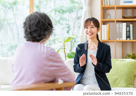 Young business woman selling to senior women Young business woman selling to senior women 94835370