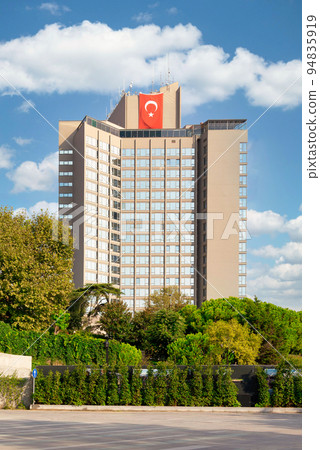 Exterior of modern tall building of InterContinental five stars hotel, framed by green trees, Istanbul, Turkey Exterior of modern tall building of InterContinental five stars hotel, framed by green trees, Istanbul, Turkey 94835919