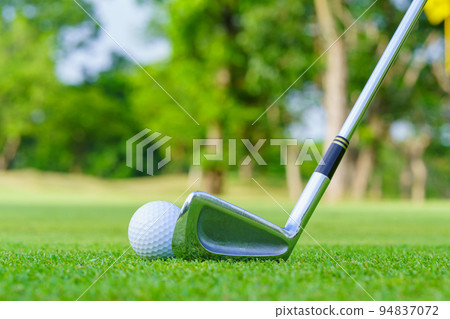 Golf ball on green grass ready to be struck on golf course Golf ball on green grass ready to be struck on golf course 94837072