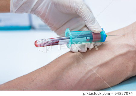 Nurse collecting a blood from patient in hospital 94837074