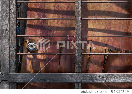 Old frames and shutters from dismantled are stacked against each other front of front warehouse waiting to be sold at auction. 94837209