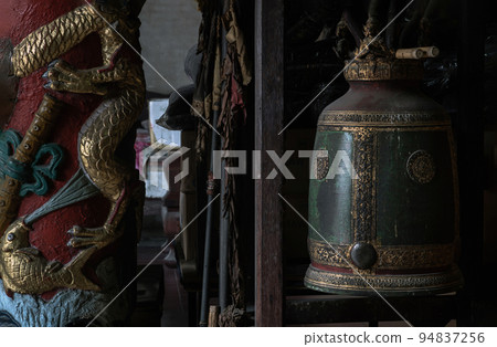 Sculptured golden dragons red pillar and Traditional old green iron bell hanging in Phutthamonthon sathan. Sculptured golden dragons red pillar and Traditional old green iron bell hanging in Phutthamonthon sathan. 94837256