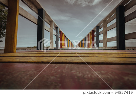 The walkway on Rainbow bridge or Old wood colorful bridge pier. The walkway on Rainbow bridge or Old wood colorful bridge pier. 94837419