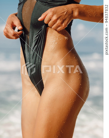 Body of attractive slim woman in bikini at tropical beach. Tanned girl model at ocean 94837832