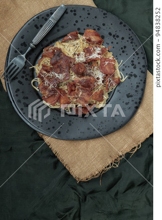 Truffle carbonara spaghetti with fried bacon and grated cheese in ceramic plate. Truffle carbonara spaghetti with fried bacon and grated cheese in ceramic plate. 94838252