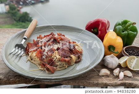 Truffle carbonara spaghetti with fried bacon and grated cheese in ceramic plate. 94838280