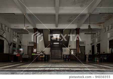 The view from the outside into inside lobby of a Sri Hualampong Hotel. Architecture traditional of old wooden stairs and old wooden pillars. 94838355