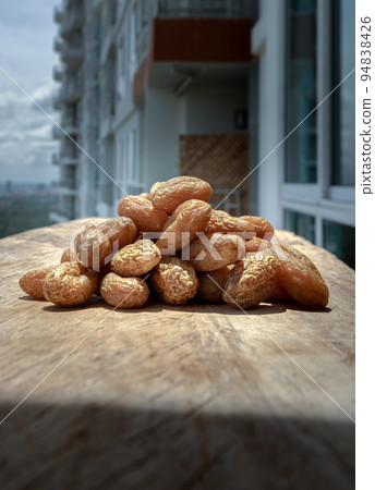 Terminalia bellerica or Terminalia chebula (Organic dry harad). Dried fruits on Rustic old wooden background. 94838426