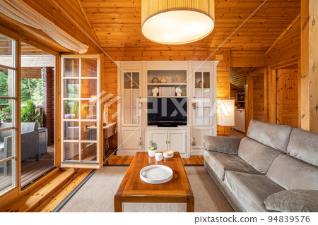 Cozy interior of a country house in a wooden design. Spacious living room on the second floor 94839576