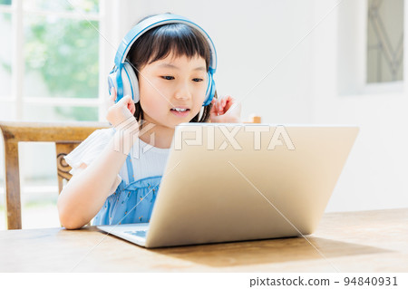 Elementary school girl taking online lessons 94840931