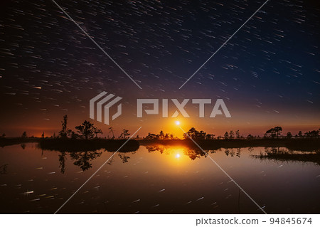 Abstract Sunset Trace Of Sun Above Rural Landscape. Soft Colors. Bright Dramatic Trails Of Stars And Meteors. Stars Effect In Sky. Unusual Dusk Natural Background Abstract Sunset Trace Of Sun Above Rural Landscape. Soft Colors. Bright Dramatic Trails Of Stars And Meteors. Stars Effect In Sky. Unusual Dusk Natural Background 94845674