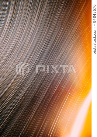 Meteors Trace On Night Dark Blue Sky Background. Spin Of Unusual Amazing Stars Effect In Sky. Abstract Bewitching Illusion Of Star Trails. Trace Of Sun. Saturated Bright Yellow, Orange Colors 94845676