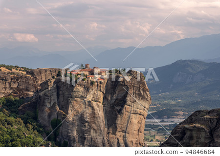 The Holy Monastery of St. Stephen in the rays of the setting sun, Holy Meteora complex in Greece The Holy Monastery of St. Stephen in the rays of the setting sun, Holy Meteora complex in Greece 94846684