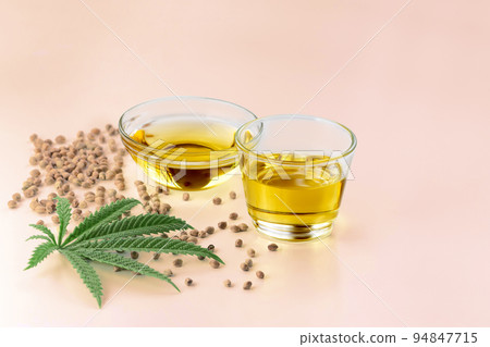 Legalized marijuana concept CBD oil in glass bowl and bottle with dropper lid. 94847715