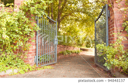 Garden with brick walls and iron gates 94848137