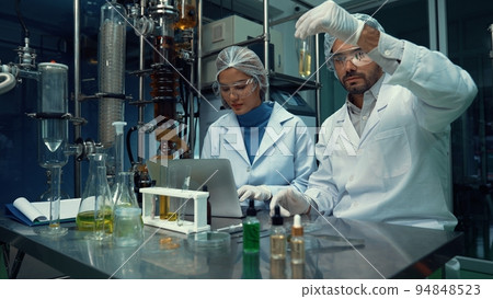 Two scientist in professional uniform working in laboratory 94848523
