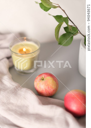 autumn aesthetic still life with apples and glowing candle. blog content. fall evening mood. selective focus, vertical autumn aesthetic still life with apples and glowing candle. blog content. fall evening mood. selective focus, vertical 94848671