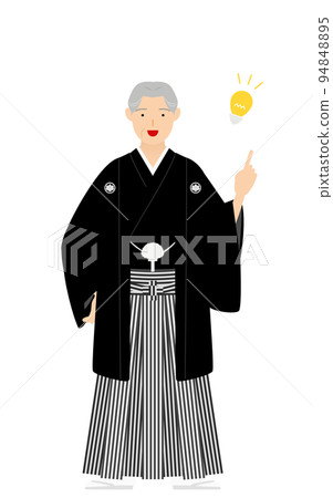 Senior man with a crested hakama (in Japanese clothes) points and gives advice 94848895