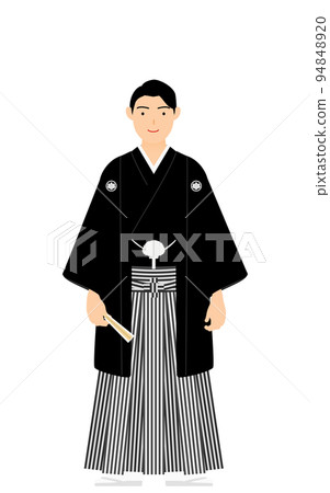 A man with a crested hakama (in Japanese clothes) poses with a fan 94848920