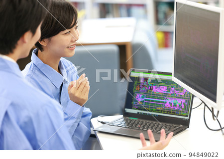 A female designer receiving an explanation of CAD design from seniors_4 94849022