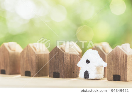 White house in among wooden house for real estate. planning savings money of coins to buy a home 94849421